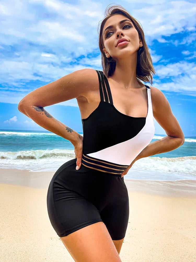 Maillot de bain une pièce noir avec empiècement blanc, rayures dorées à la taille.