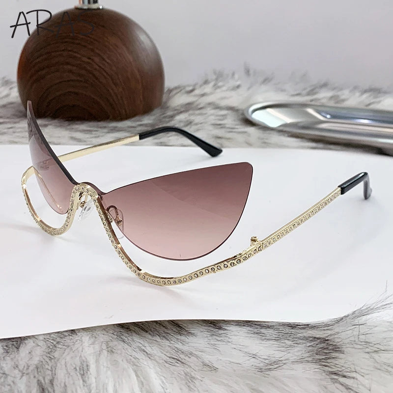 Lunettes de soleil œil-de-chat monture dorée strass verres roses teintés
