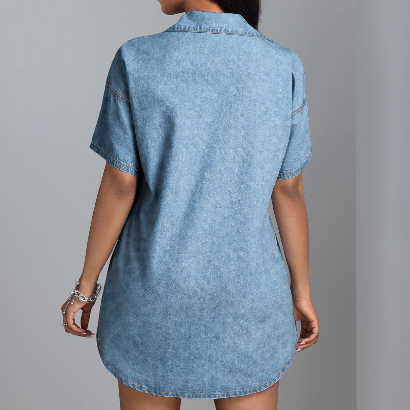 Robe chemise en jean bleu clair, vue arrière, col claudine, coutures et boutons au dos.