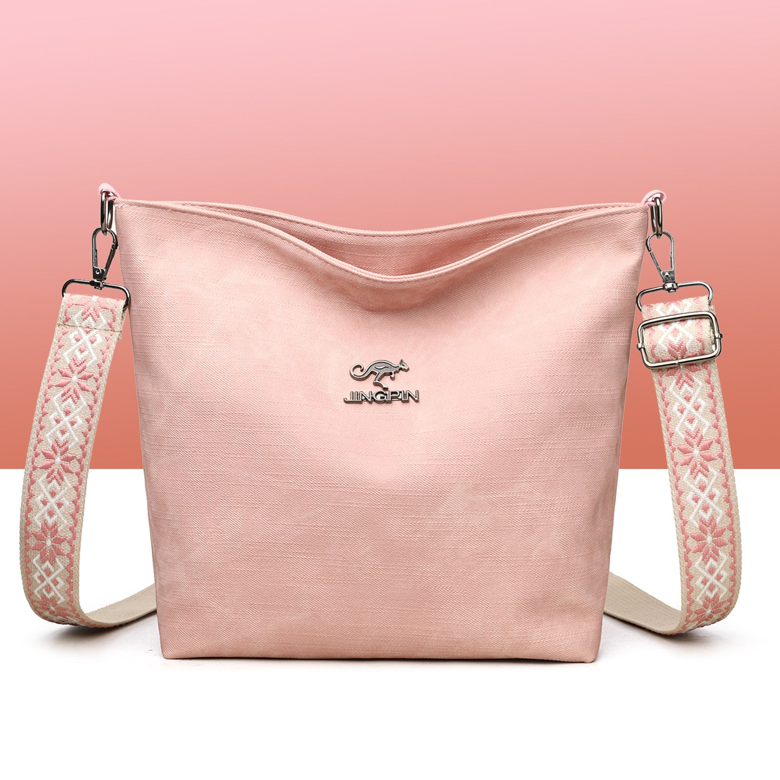 Sac à main souple rose grand format avec bandoulière à motifs et logo, zip en haut