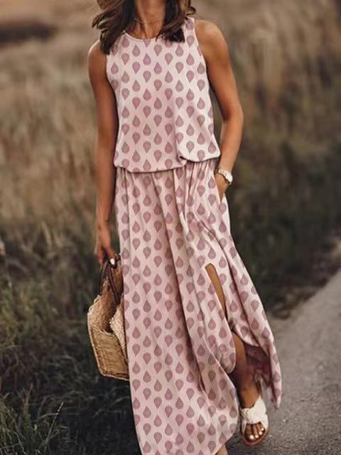 Robe longue sans manches à col rond, blanc à pois rose, fente latérale et poches