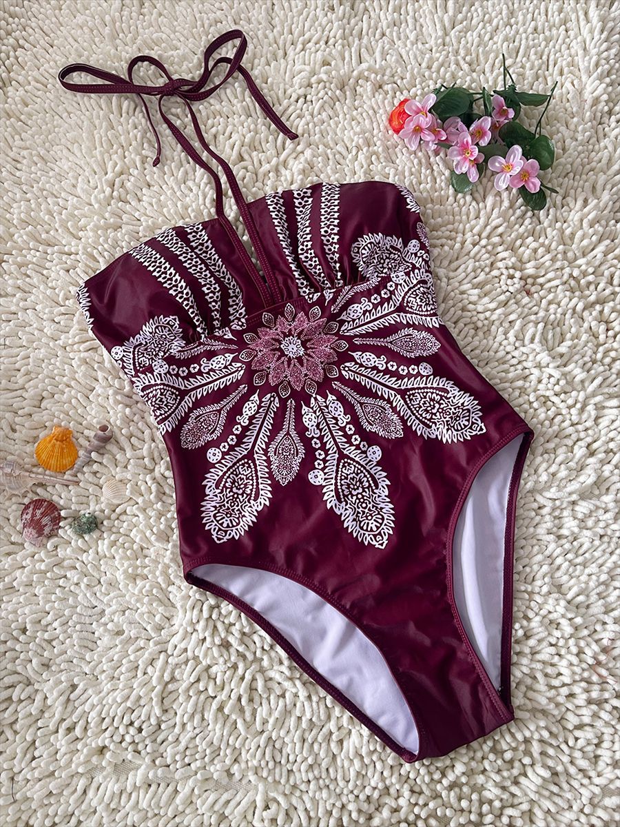 Maillot de bain une pièce bordeaux imprimé blanc, décolleté V et bretelles croisées
