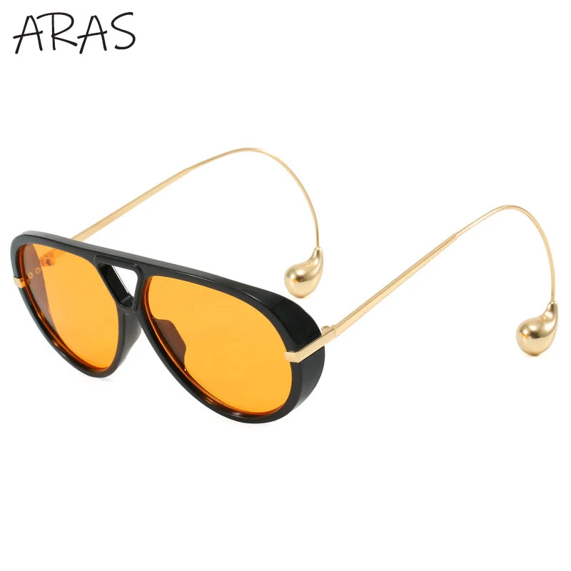 Lunettes de soleil ovales surdimensionnées vue de côté, verres orange et monture noire