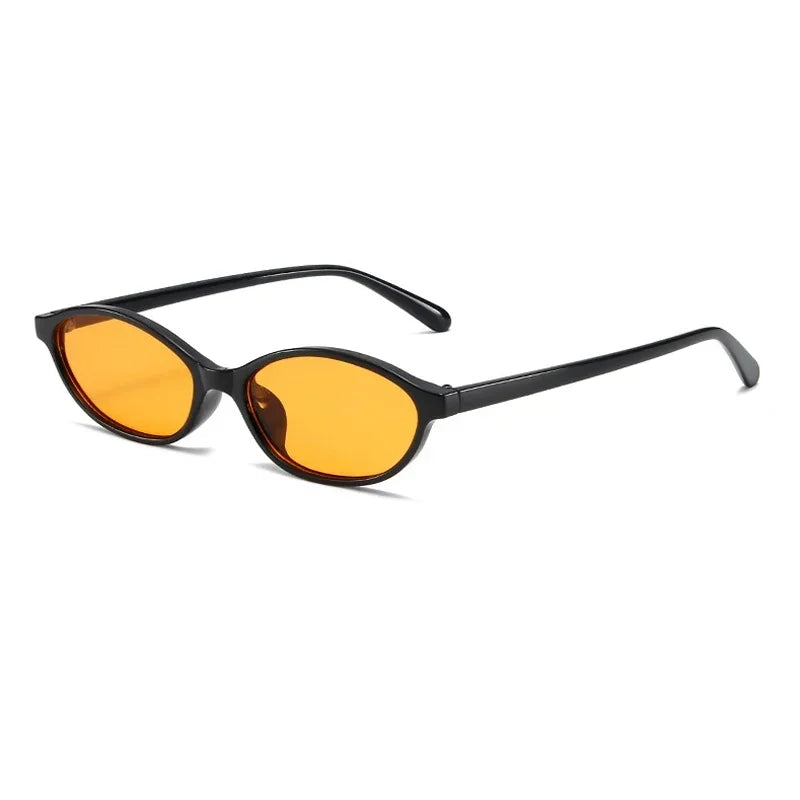 Lunettes de soleil à monture noire, verres ambrés, forme ovale, style œil-de-chat