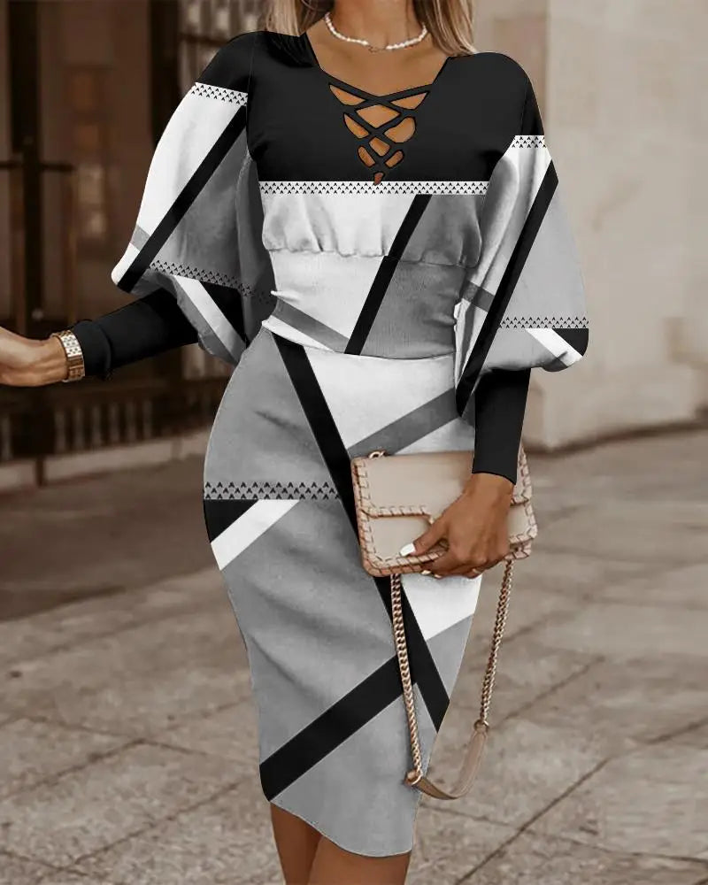 Robe midi à col en V croisé, manches longues, imprimé géométrique noir et blanc.