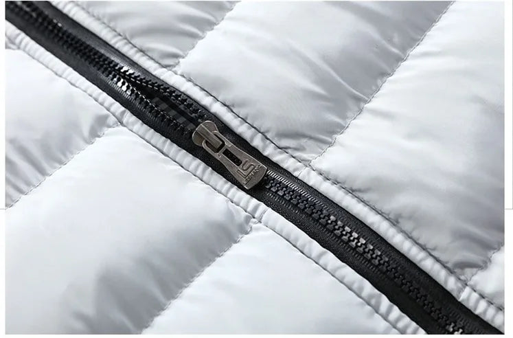 Gros plan de la fermeture zippée noire sur gilet matelassé gris clair