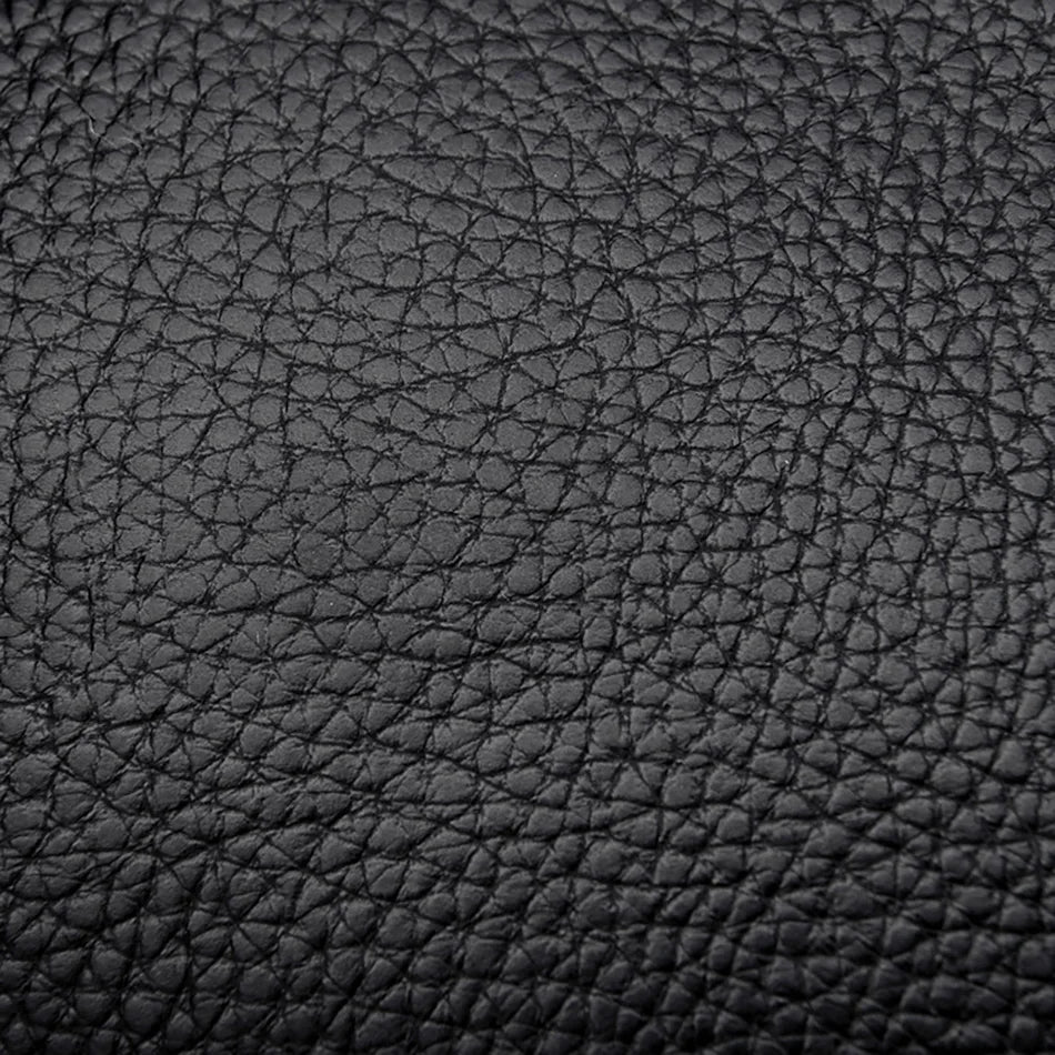 Surface en cuir noir grainé, texture visuelle détaillée