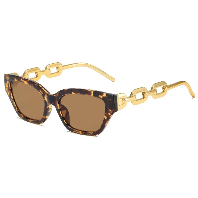 Lunettes de soleil œil de chat écaille, verres bruns, charnière dorée.