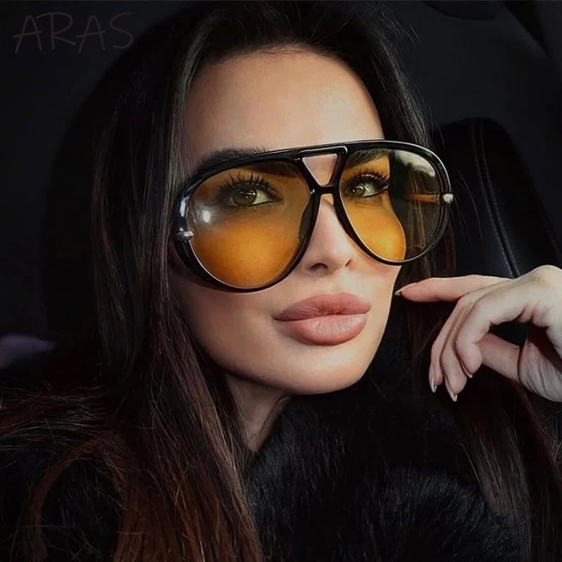 Lunettes de soleil ovales surdimensionnées à monture noire et verres orange