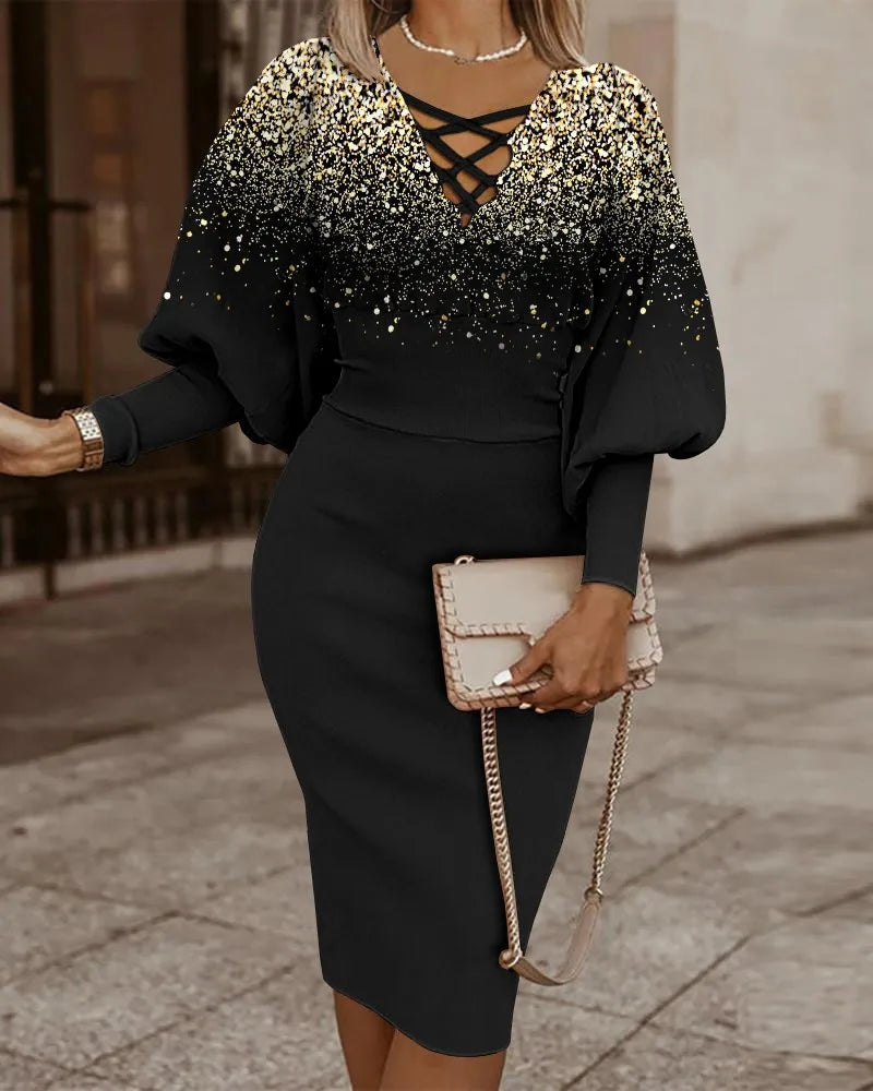 Robe midi noire à col en V et encolure croisée, manches longues, motif pailleté doré.