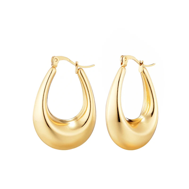 Boucles d’oreilles créoles épaisses dorées, paire symétrique, aperçu avant.