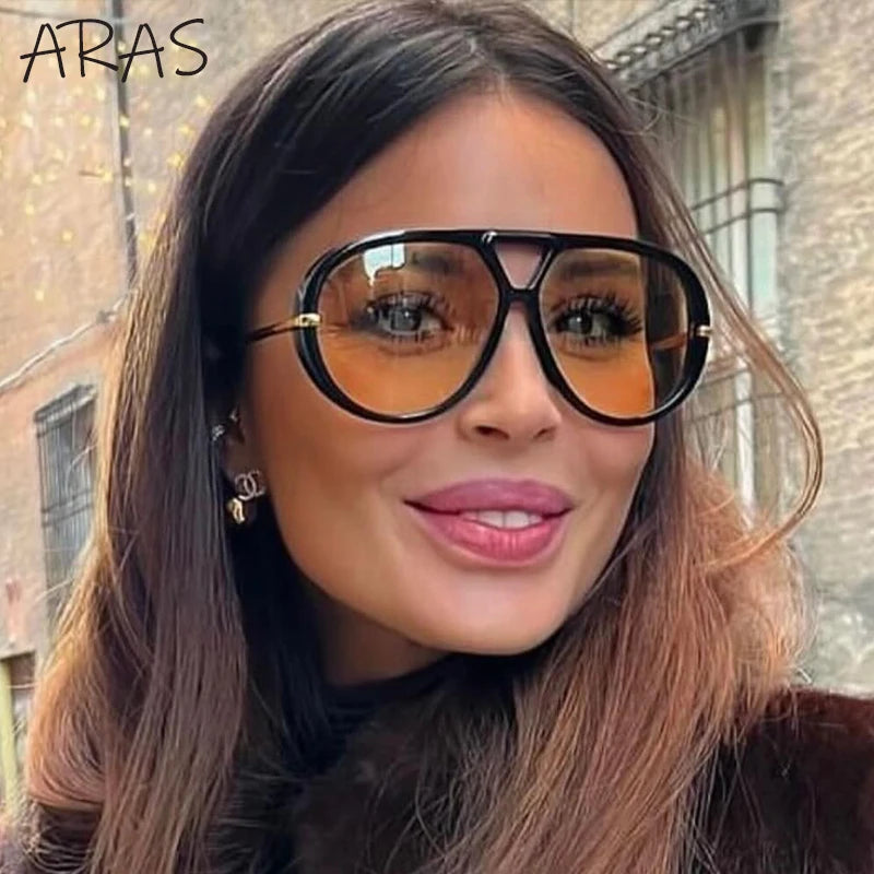 Lunettes de soleil ovales surdimensionnées à monture noire et verres orange