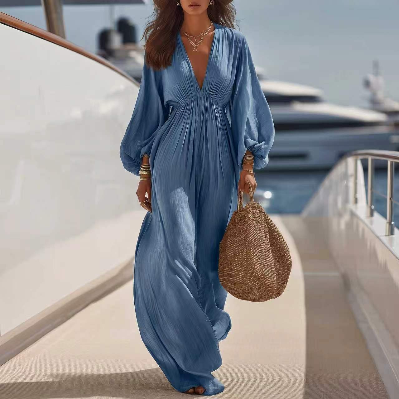 Combinaison ample col V manches longues, tissu bleu moyen plissé, jambes larges.